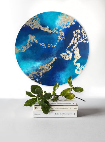 Golden Dreams is a 50cm round wall art piece created in a resin art style that features beautiful teal and blue resin and flashy gold leaf details